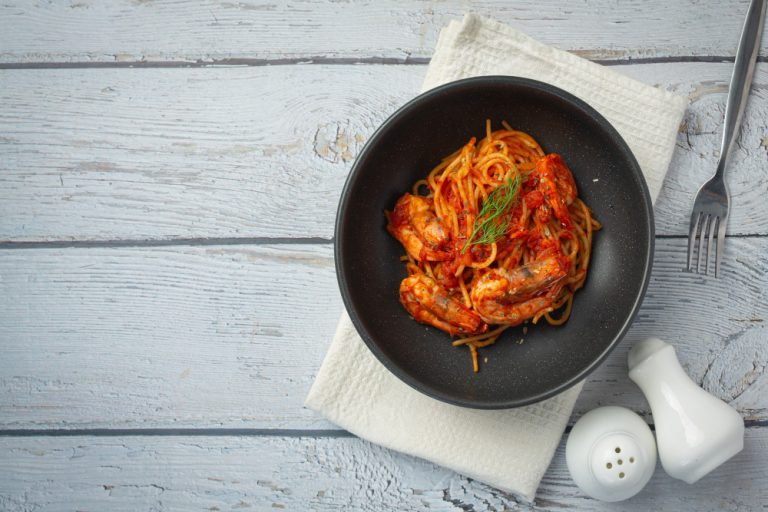 spaghetti-with-shrimps-tomato-sauce-white-wooden-background